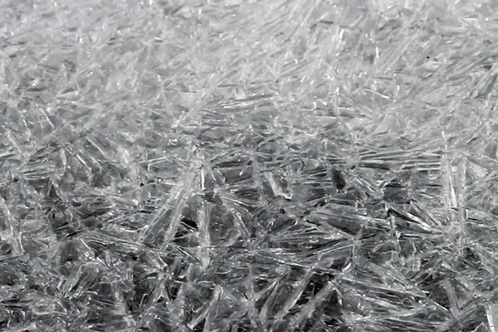 A close-up of ice crystal fragments. It appears like cracked glass. 