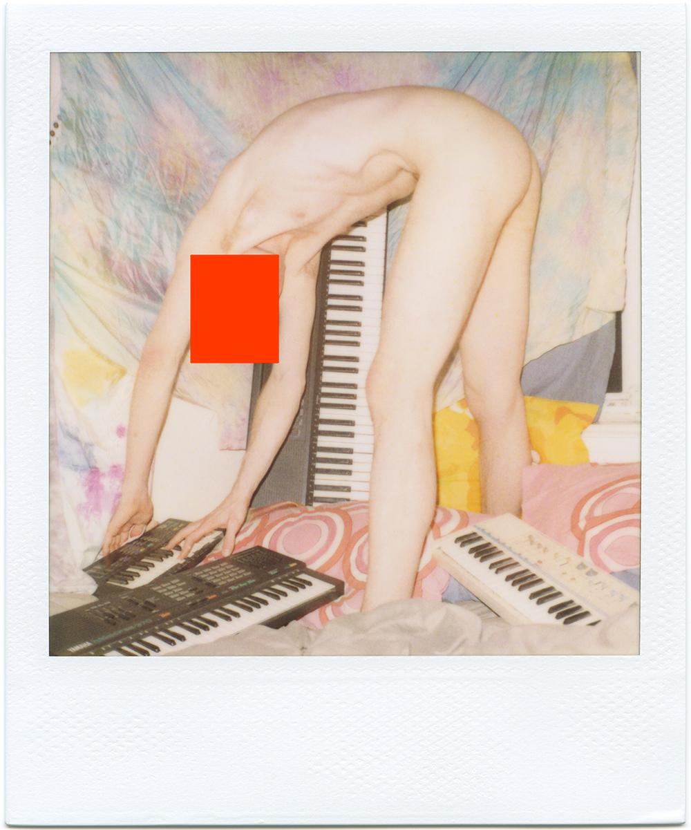 A thin white body is arched over four keyboards on the ground, playing the smallest of them. There is a pastel tie-dyed tapestry hanging in the background. A red square is positioned over the figure’s face, concealing it.